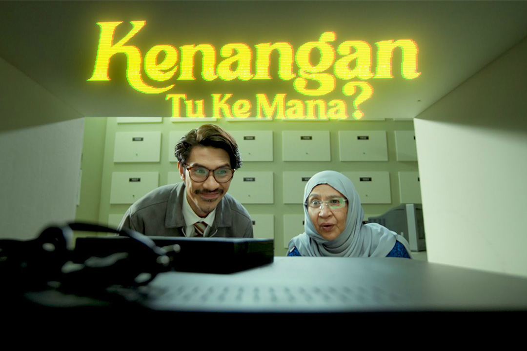 Two people staring at a computer screen for campaign Kenangan Tu Ke Mana?