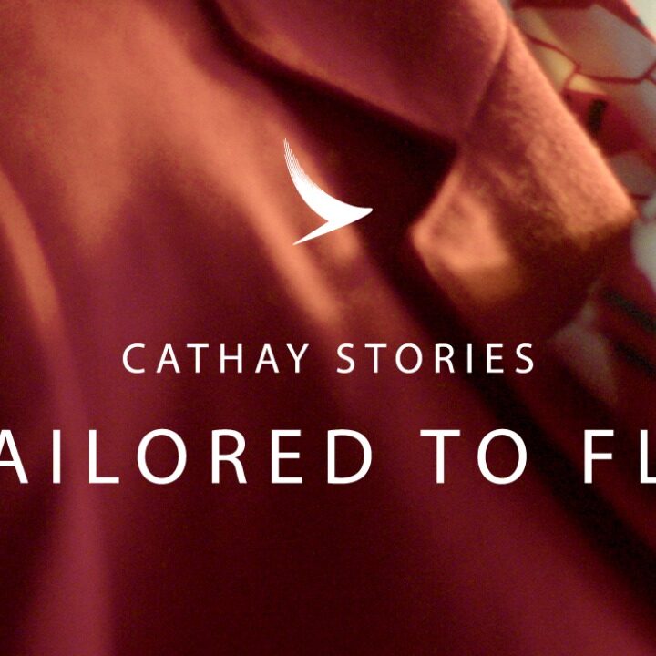 Close up of flight attendant's wearing red blazer for Cathay Pacific