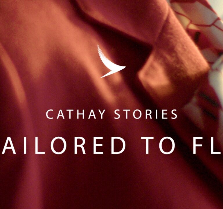 Close up of flight attendant's wearing red blazer for Cathay Pacific