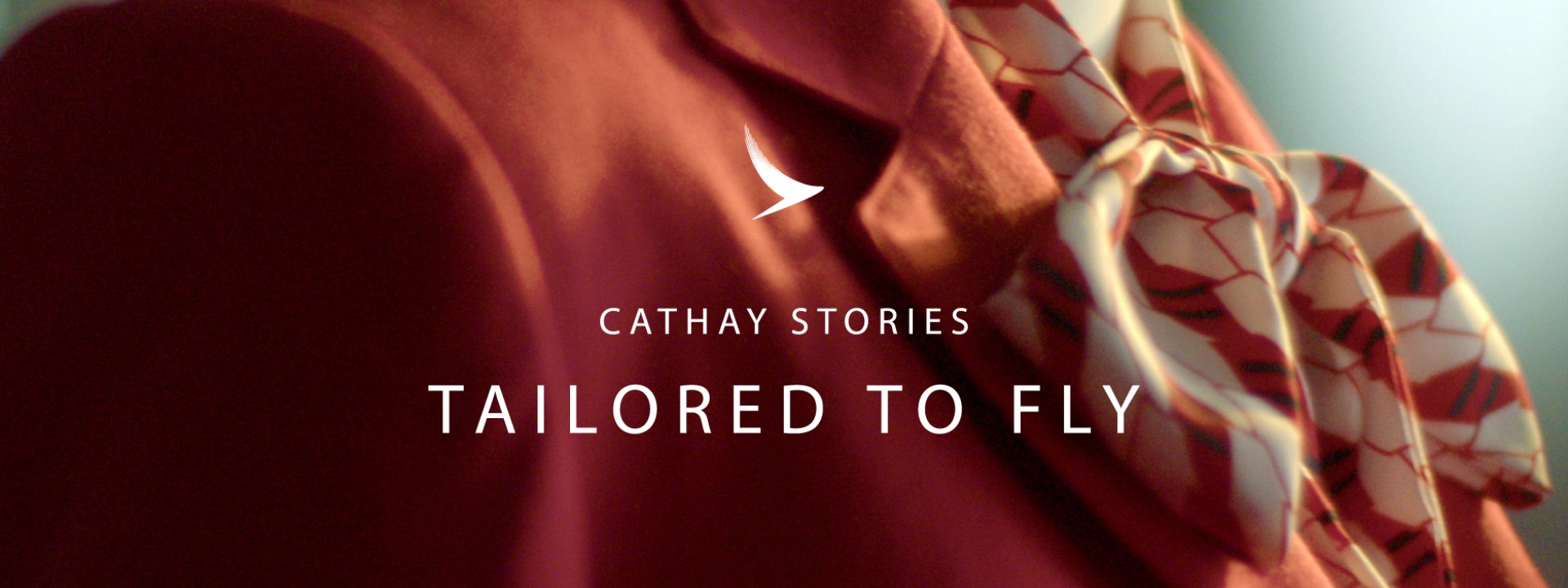 Close up of flight attendant's wearing red blazer for Cathay Pacific