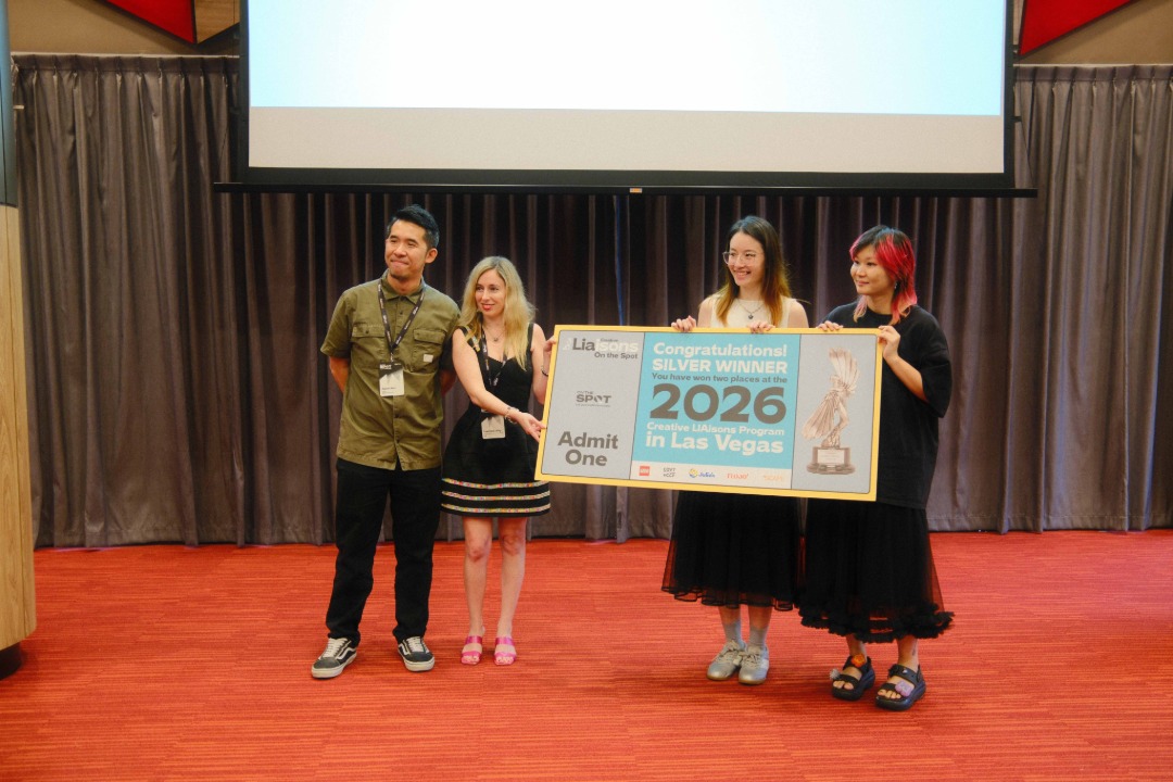 People on stage presenting a large award