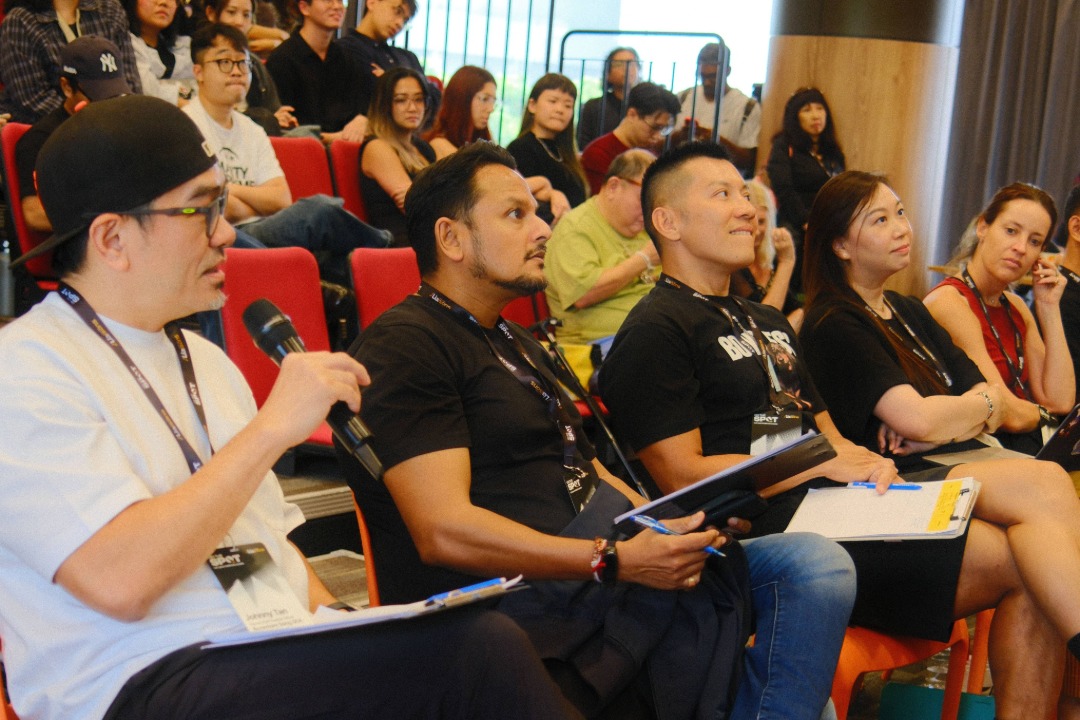 Group of people sat down for a mentoring session for young creatives in Singapore
