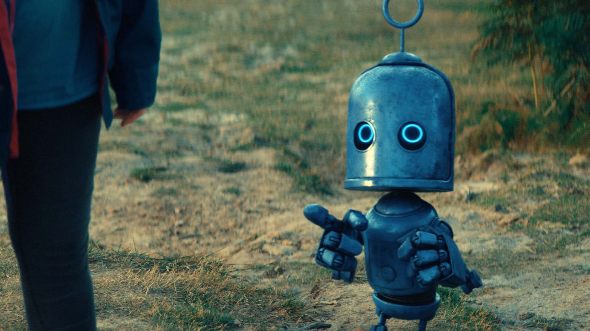 a blue robot pointing at a person