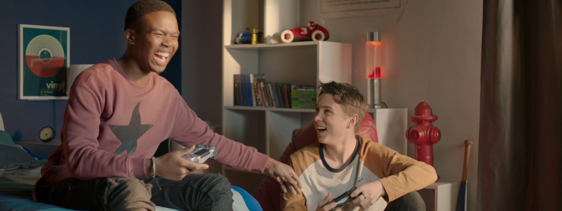 A man laughing holding a video game controller