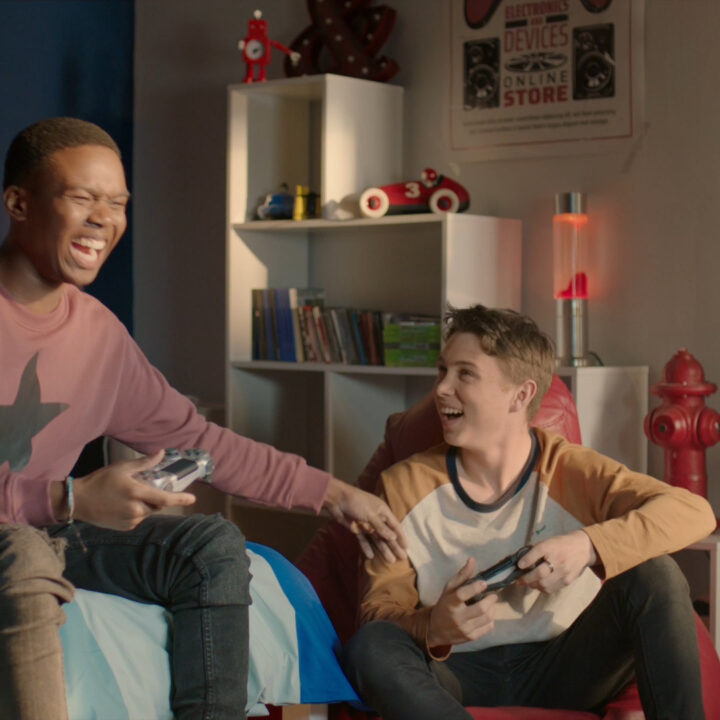 A man laughing holding a video game controller