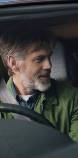 A close up of a robot in the front seat of a van