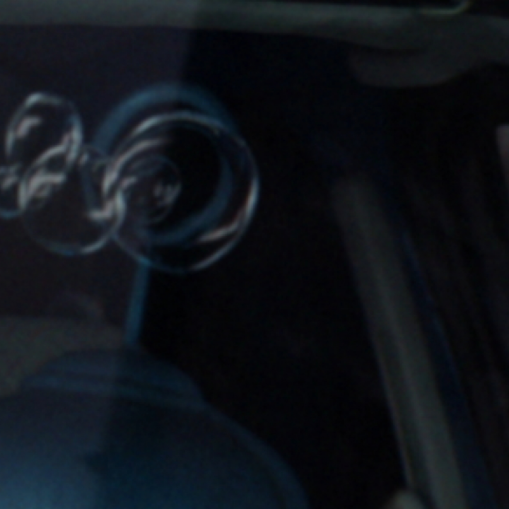 A close up of a robot in the front seat of a van