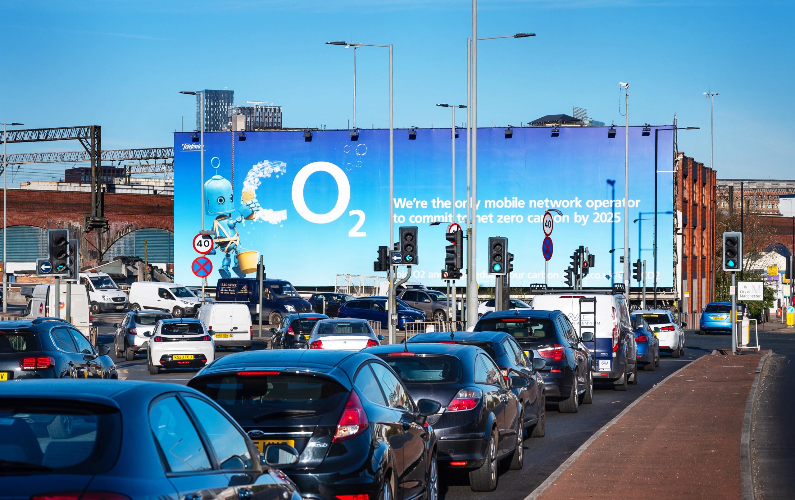 Traffic on a busy road with a billboard that reads Co2
