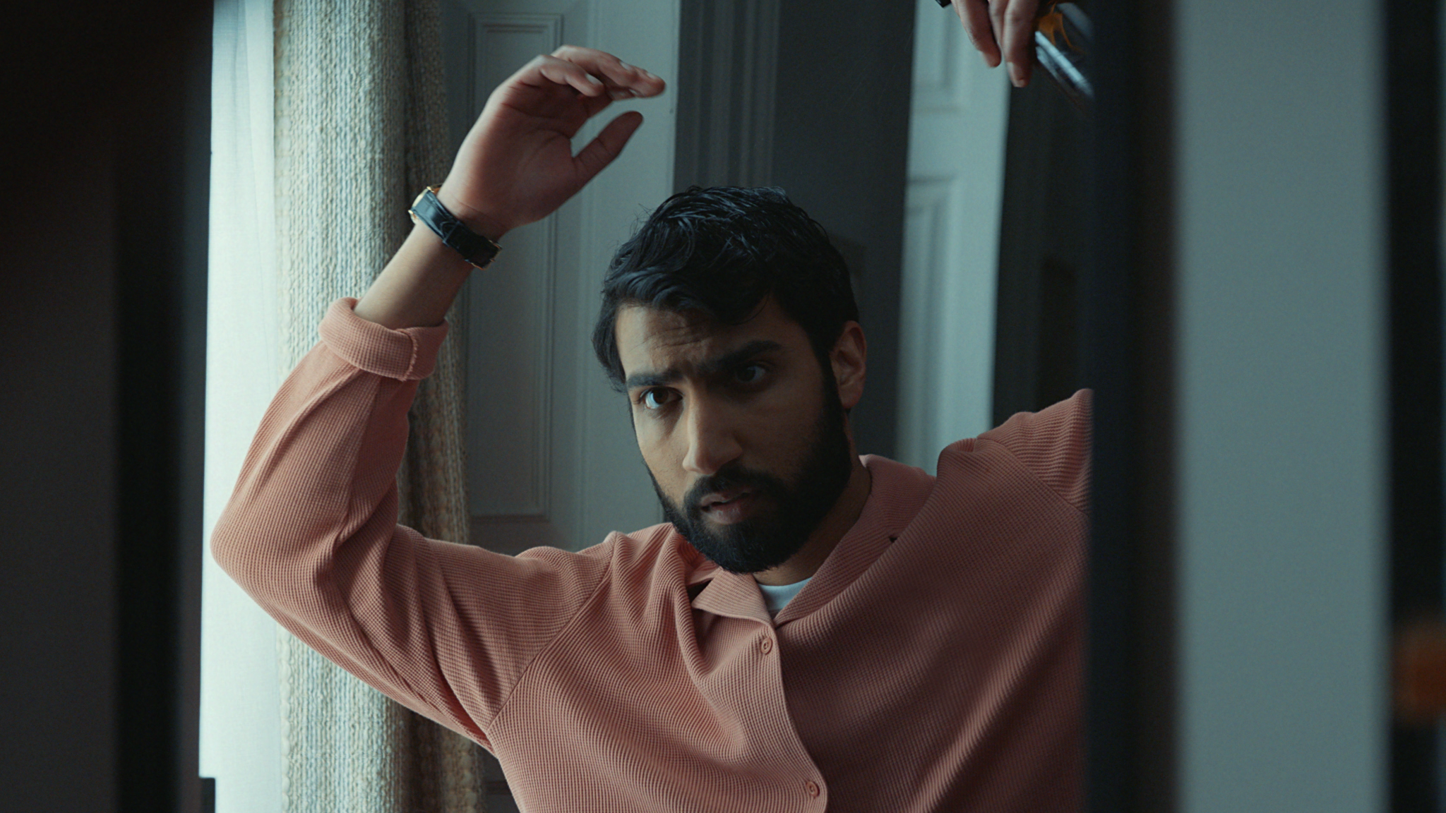 Man fixing his hair in the mirror before an interview
