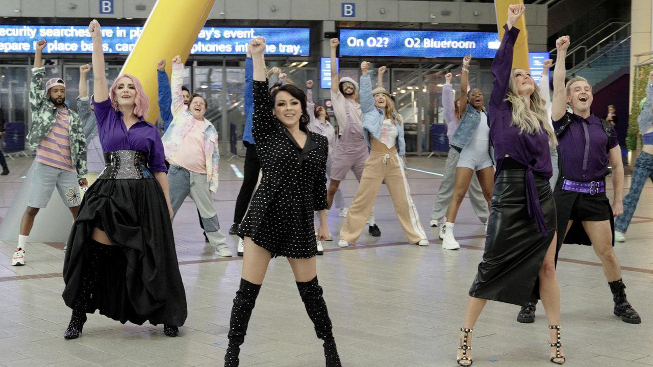 Steps standing together in the middle of a flash mob in the O2 arena.