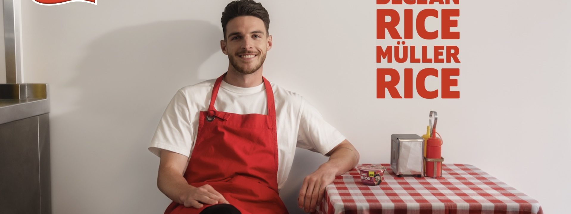 Declan Rice sat down at a checkered table with Muller rice branding