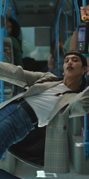Woman in Primark jeans leaning inside bus for TV Ad