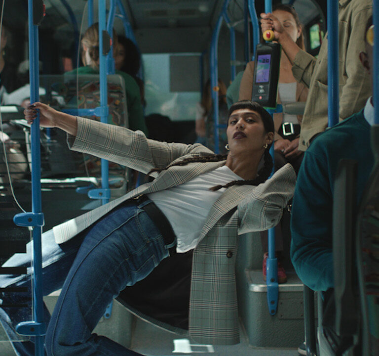 Woman in Primark jeans leaning inside bus for TV Ad