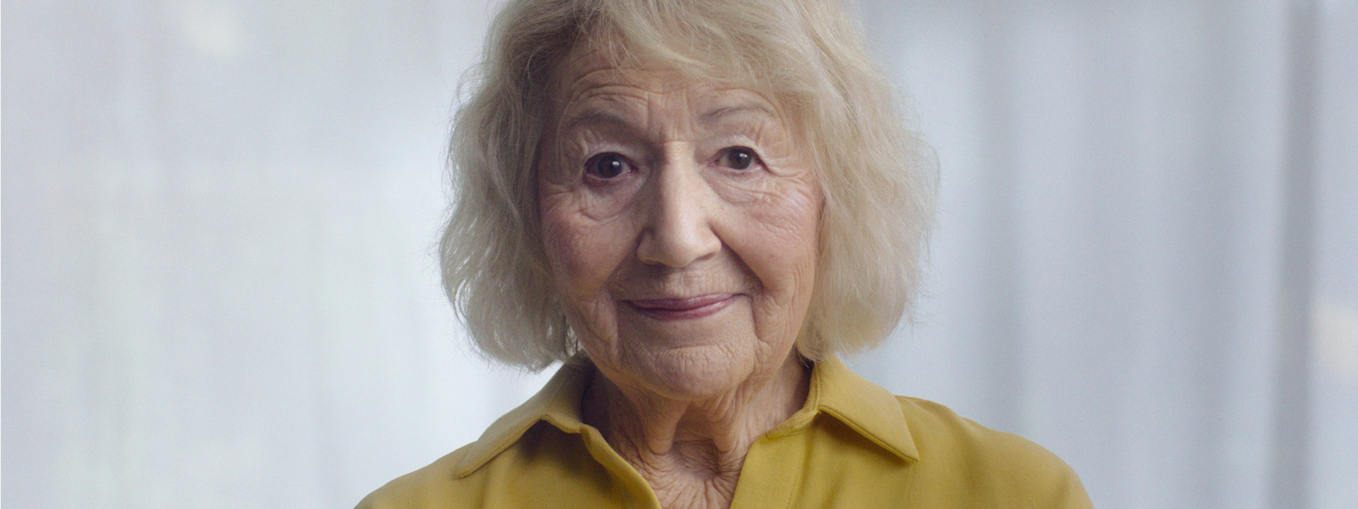 Close up of elderly woman in yellow shirt for Co-Op FuneralCare Ad