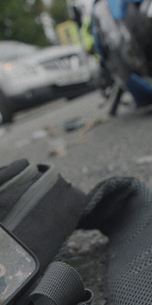 scene from a motorcycle crash with a phone left on the floor. A campaign for Transport for London