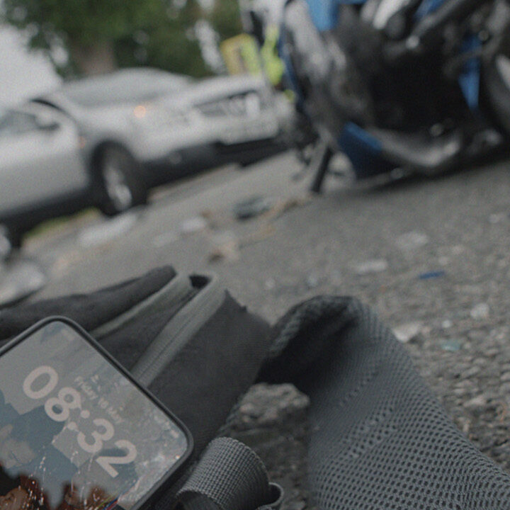 scene from a motorcycle crash with a phone left on the floor. A campaign for Transport for London