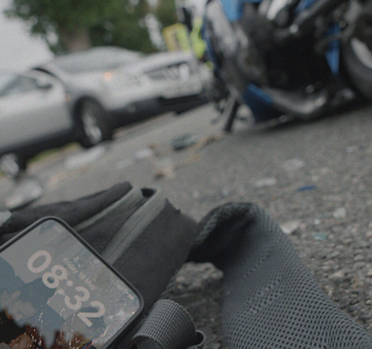 scene from a motorcycle crash with a phone left on the floor. A campaign for Transport for London