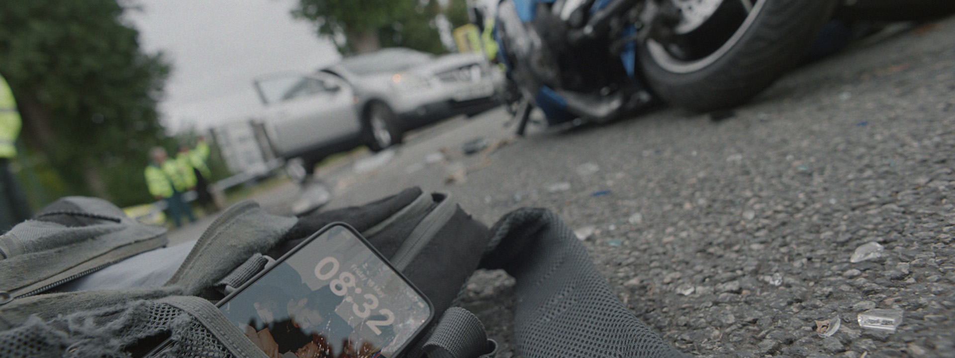 scene from a motorcycle crash with a phone left on the floor. A campaign for Transport for London