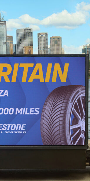 Lorry truck outside Sydney harbour bridge with Kwik Fit branding.