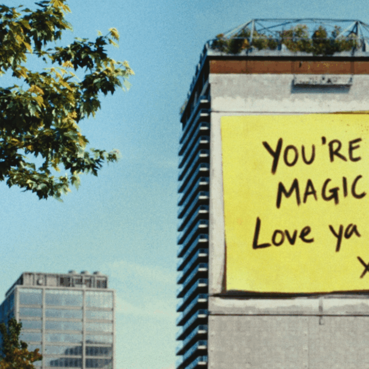 Building with large post note with 'You're Magic, love you' for Allwyn, Powerball campaign