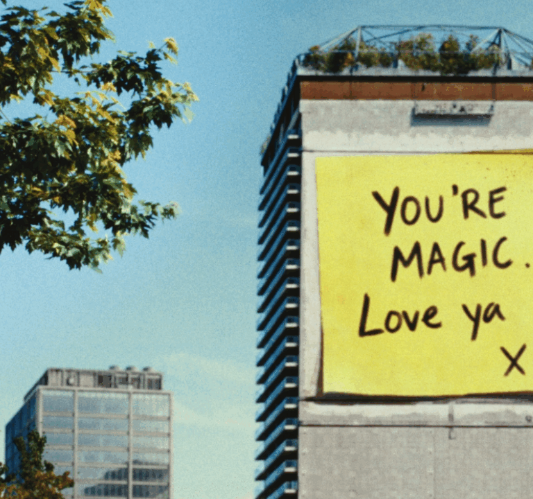 Building with large post note with 'You're Magic, love you' for Allwyn, Powerball campaign
