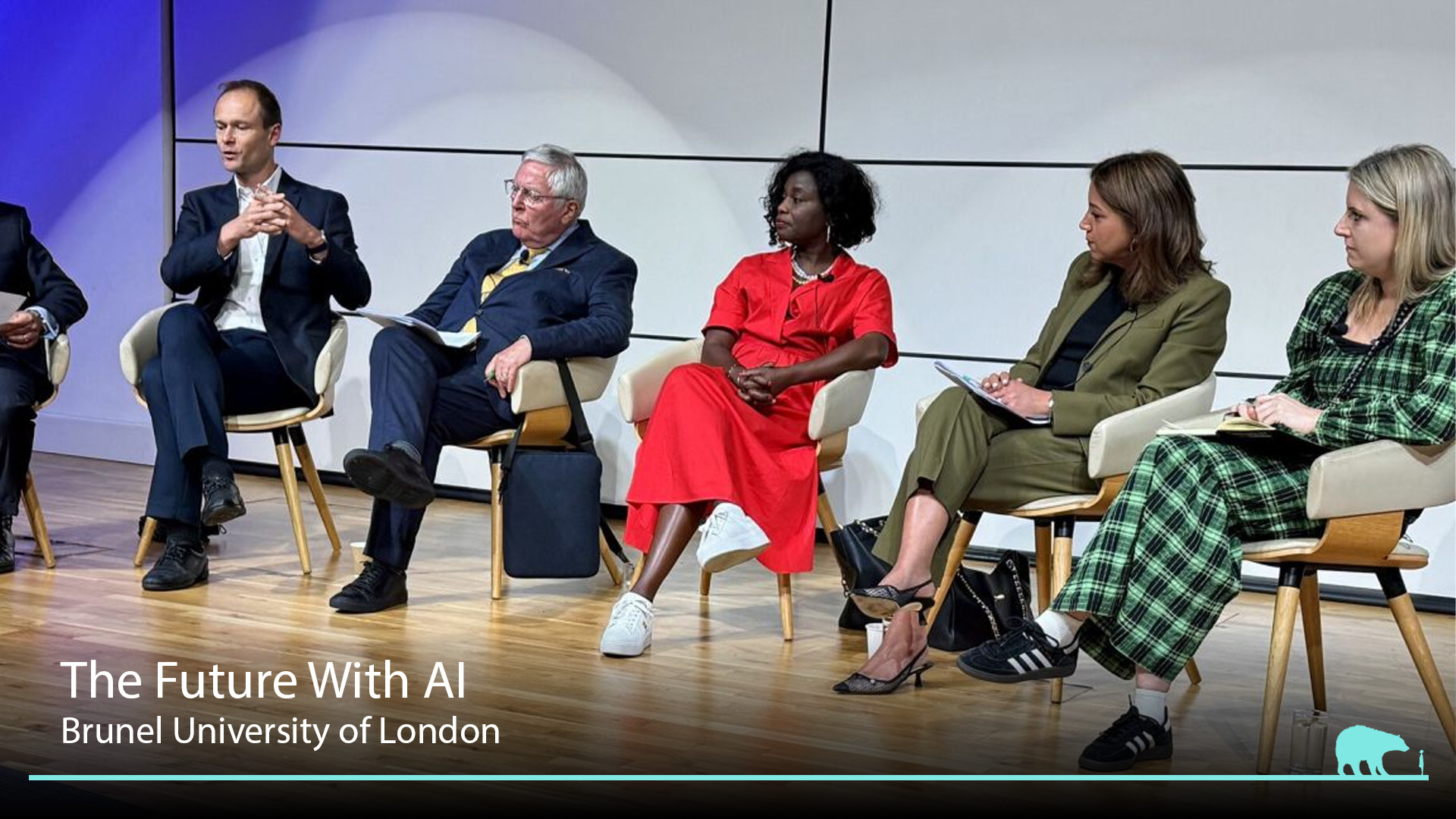 Alex Dalman sitting on a panel discussion stage at the Brunel University 60th Research Festival.