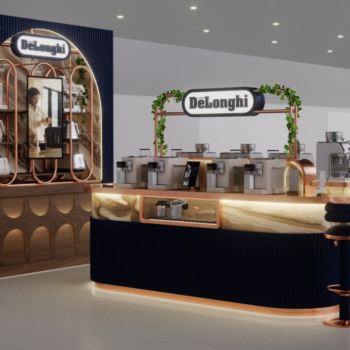 DeLonghi retail display counter featuring espresso machines, copper accents, blue fluted paneling, and bar stools.