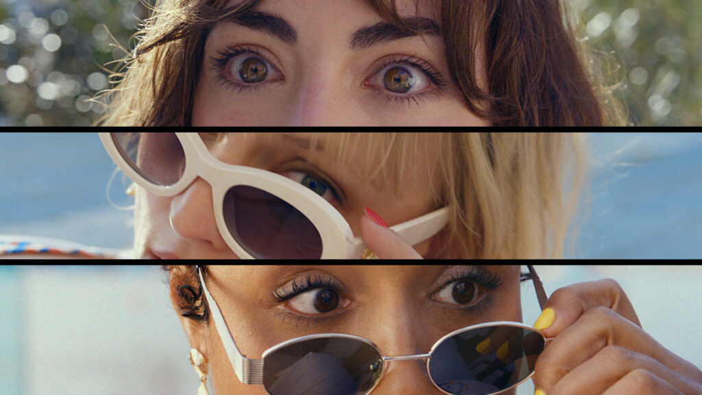 Three women in sunglasses are planning a heist