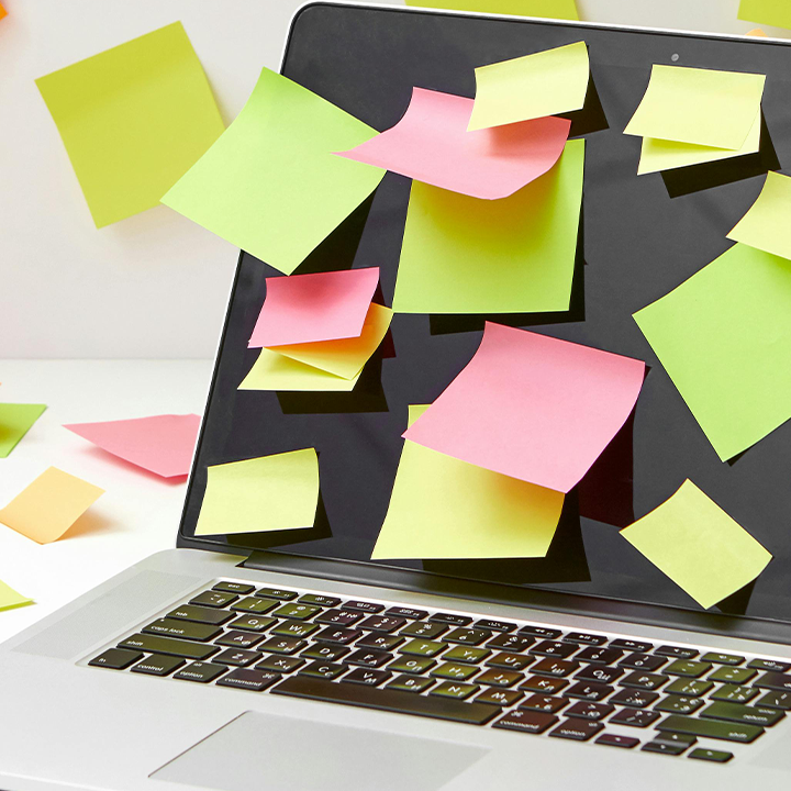 laptop with post it notes in different colours
