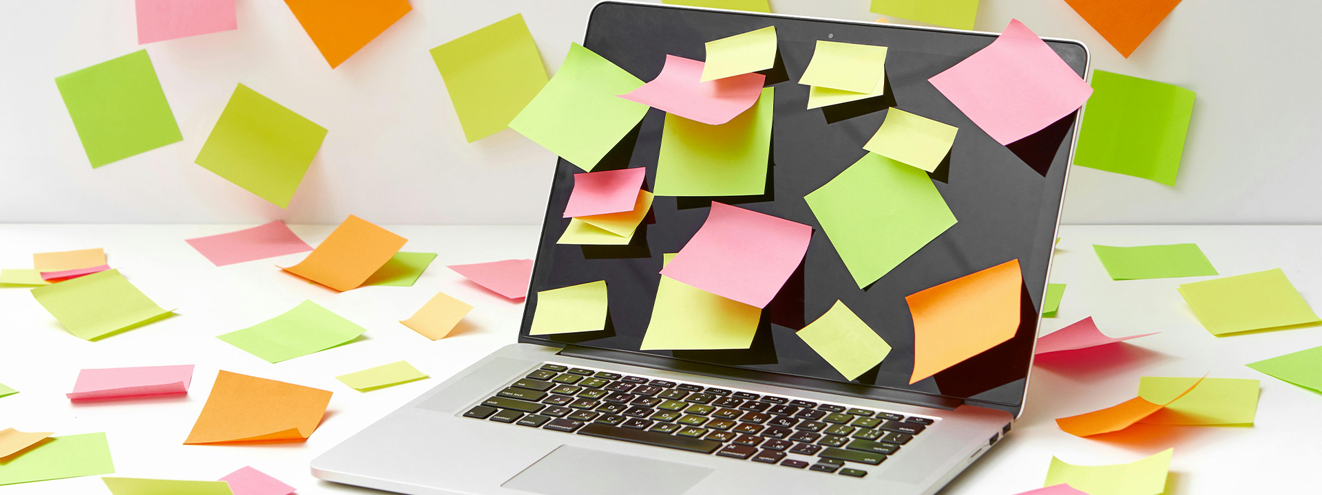 laptop with post it notes in different colours