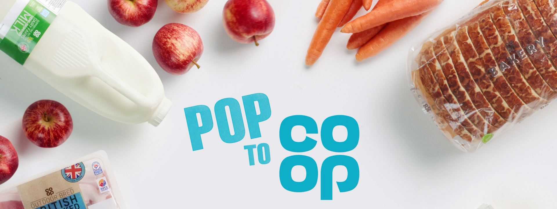 Co-op grocery campaign ad banner with blue Pop to Co-op logo surrounded by fresh produce and bakery items.