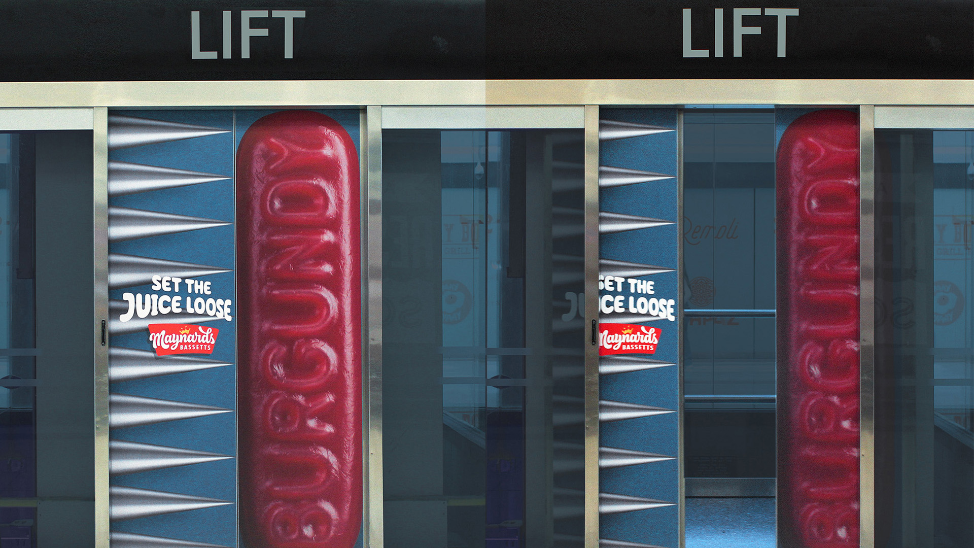 Out-of-home elevator door wrap featuring a burgundy Wine Gum candy being squished as doors shut.