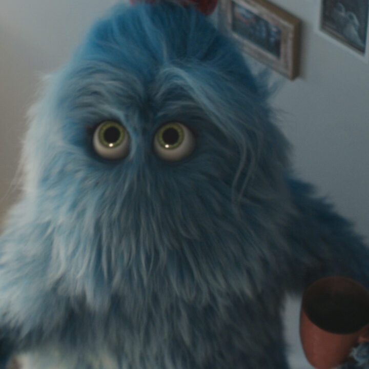Large blue furry monster character holding a mug in a hallway for British Gas ad campaign.
