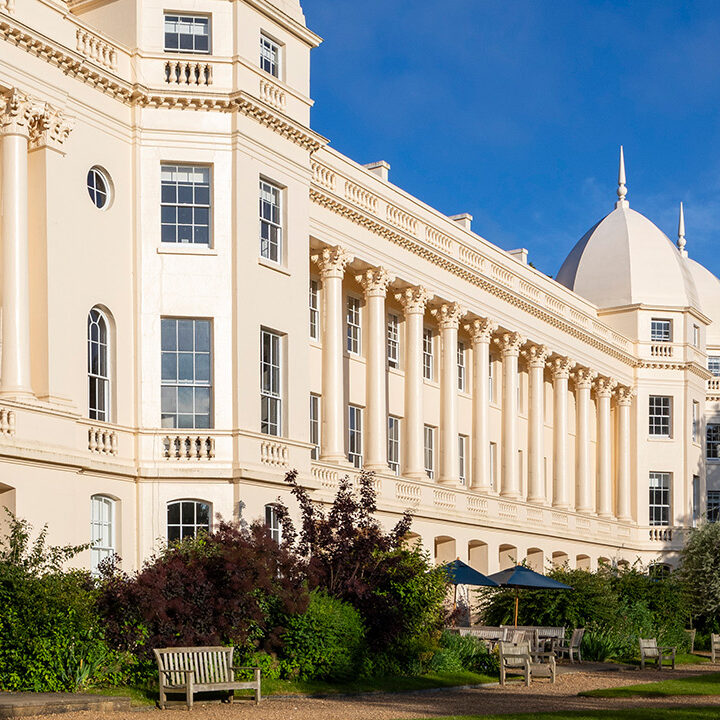 Wide banner image of London Business School's main building under a bright blue sky.