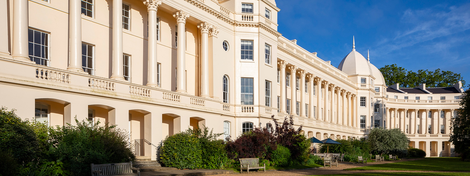 Wide banner image of London Business School's main building under a bright blue sky.