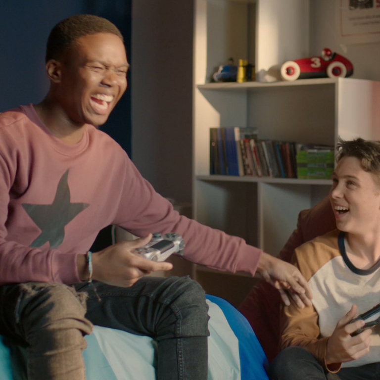 A man laughing holding a video game controller